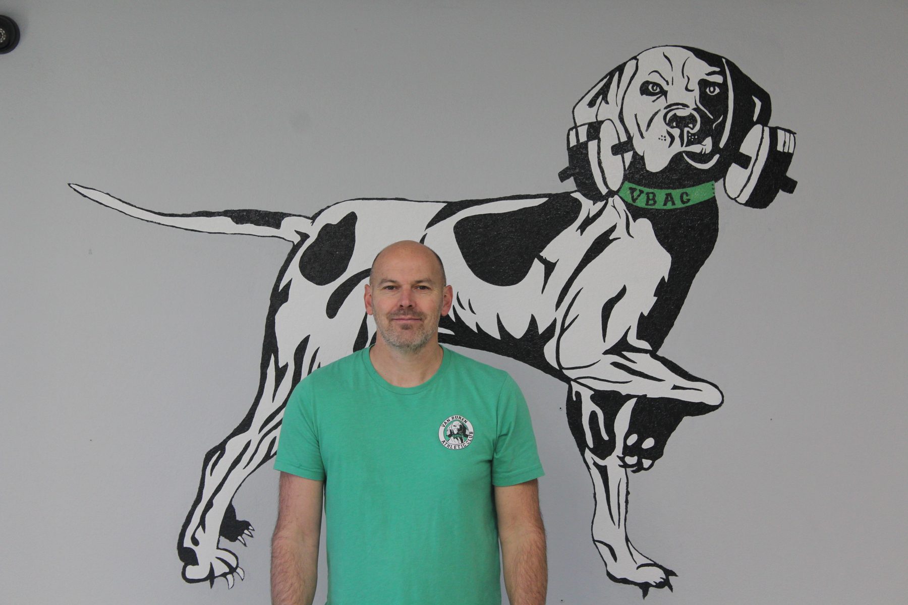 James Peck standing in front of the VBAC gym logo