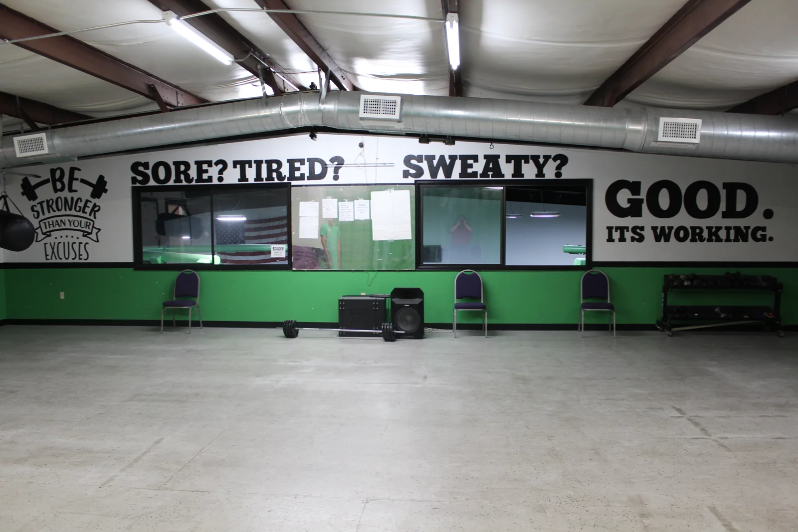 The group fitness room with open floor space and workout equipment
